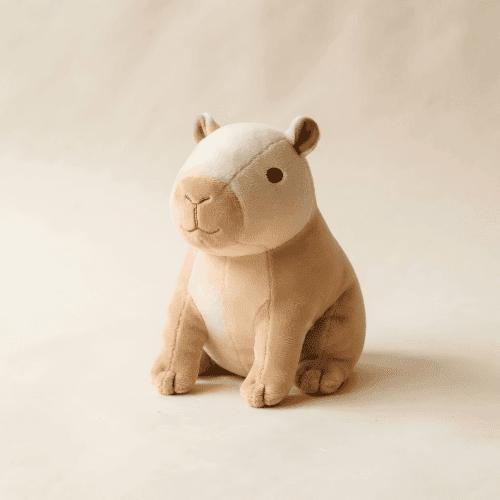 Capybara stuffed animal — specimen no. 014 A cream and tan capybara plush toy photographed on a warm paper background